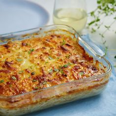 a white plate topped with lasagna covered in cheese
