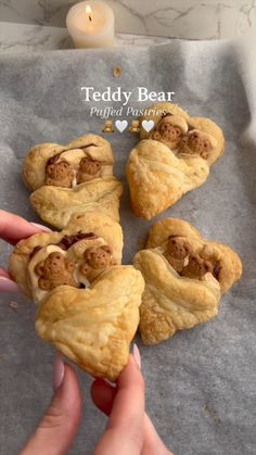 someone is holding up some heart shaped pastries
